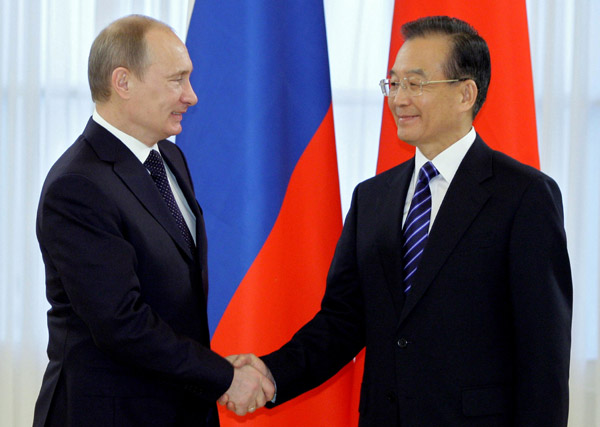 Premier Wen Jiabao shakes hands with his Russian counterpart Vladimir Putin on a visit to St. Petersburg on Tuesday.ALEXEY DRUZHININ / AFP